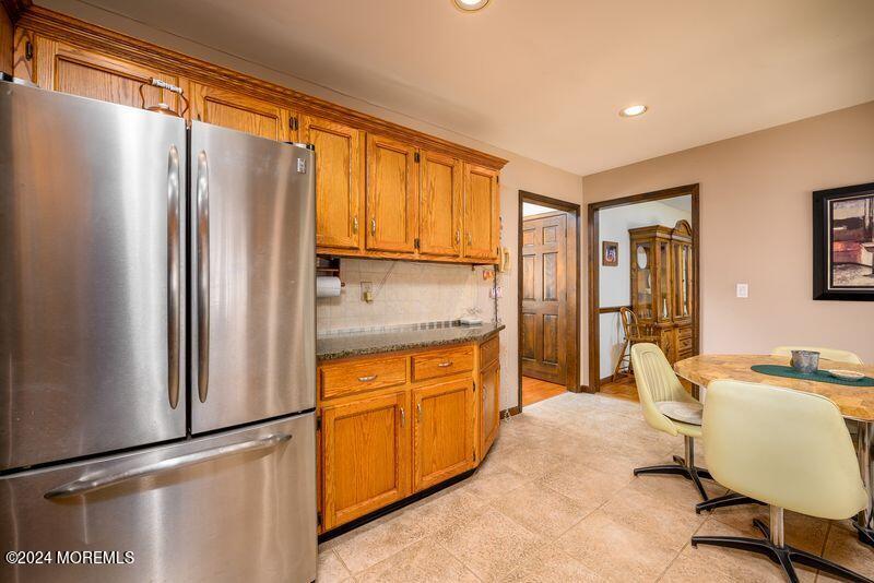 14 Spicy Pond Road Howell, NJ 07731 - Photo 4 of 35 a kitchen with stainless steel appliances granite countertop a refrigerator and a stove top oven