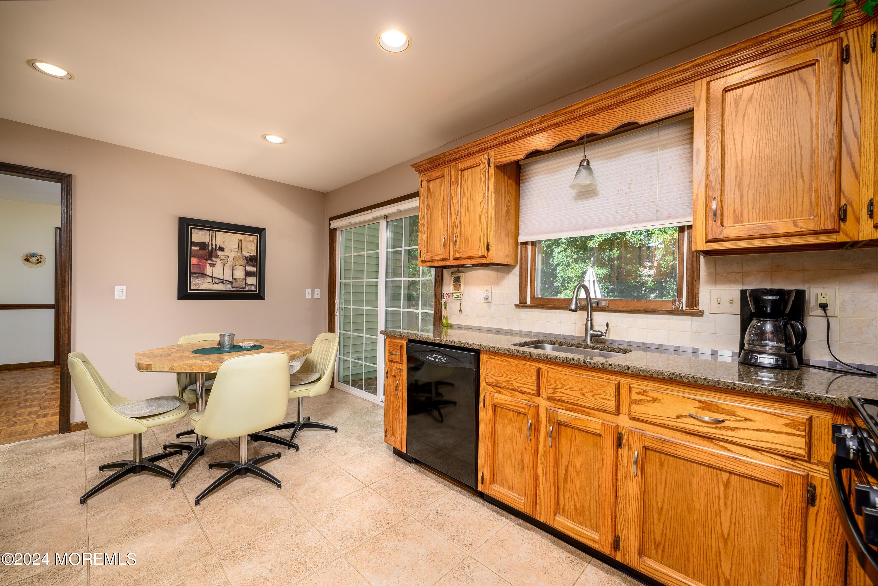 14 Spicy Pond Road Howell, NJ 07731 - Photo 5 of 35 a view of a kitchen with kitchen island granite countertop a refrigerator a sink dishwasher a dining table and chair with wooden floor