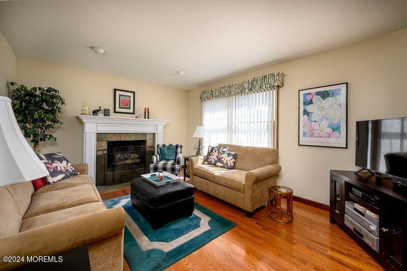 14 Spicy Pond Road Howell, NJ 07731 - Photo 9 of 35 a living room with furniture a flat screen tv and a fireplace
