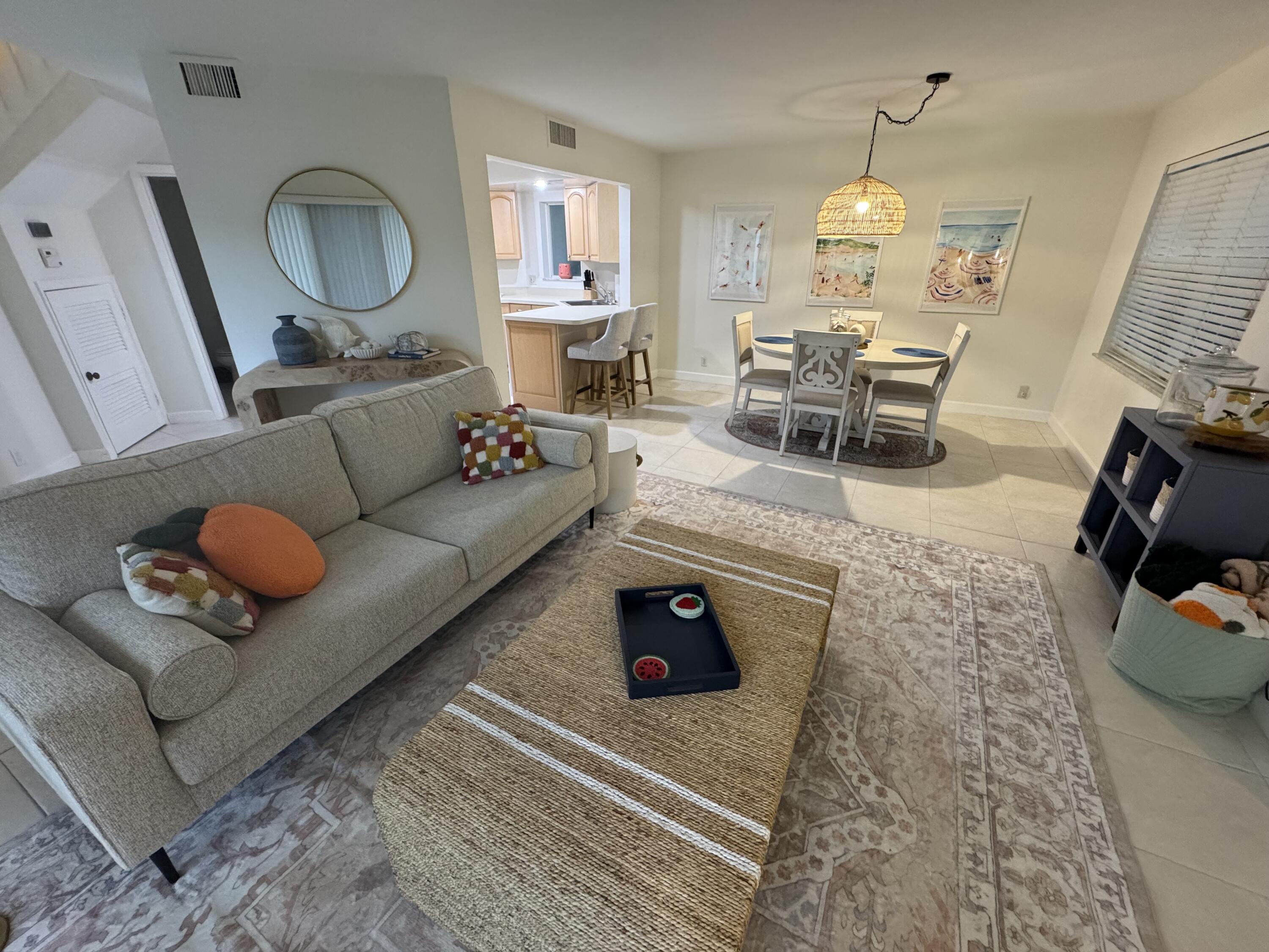 176 Seabreeze Circle Jupiter, FL 33477 - Photo 11 of 28 a living room with furniture and a wooden floor