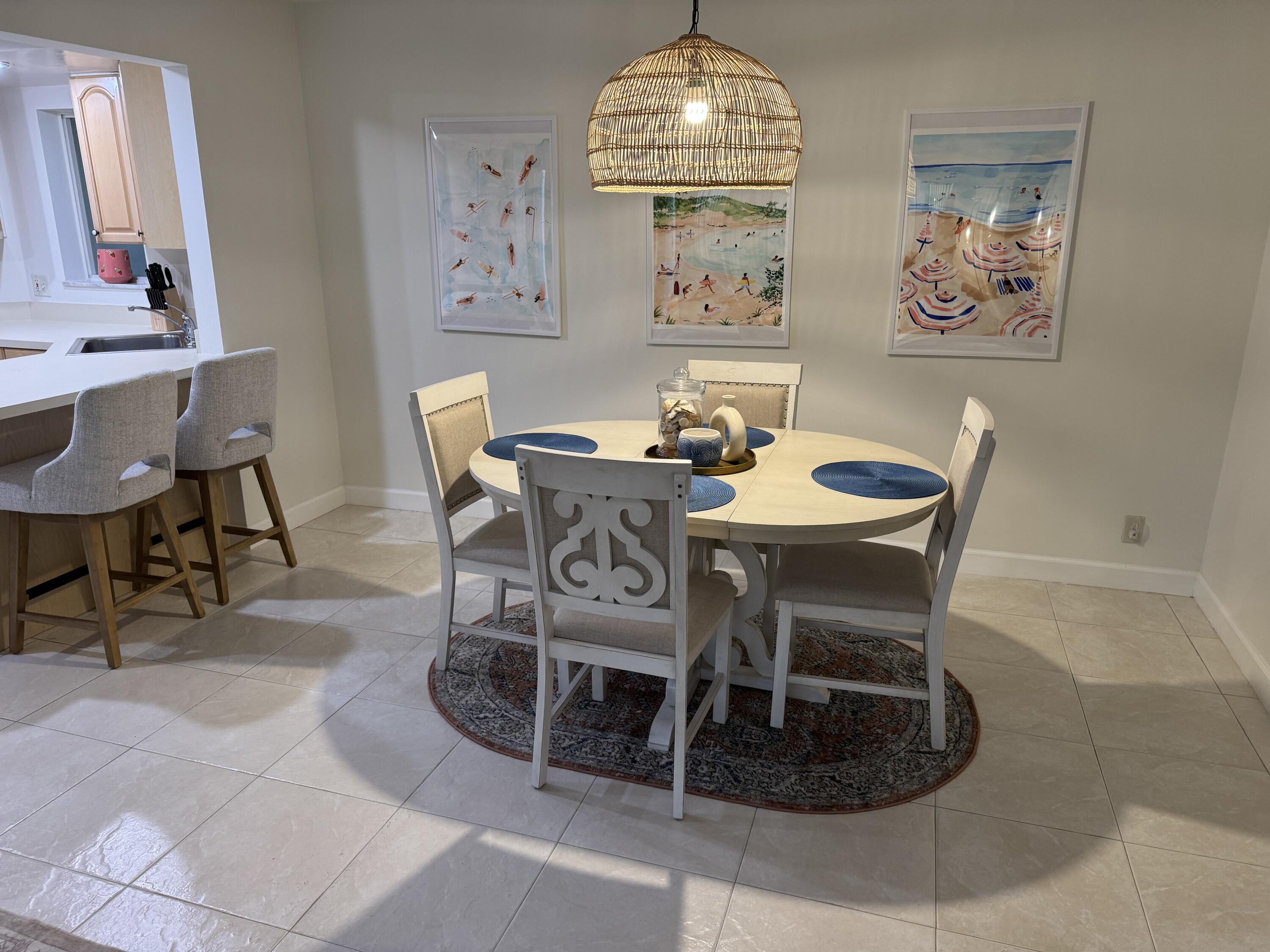 176 Seabreeze Circle Jupiter, FL 33477 - Photo 12 of 28 a view of a dining room with furniture