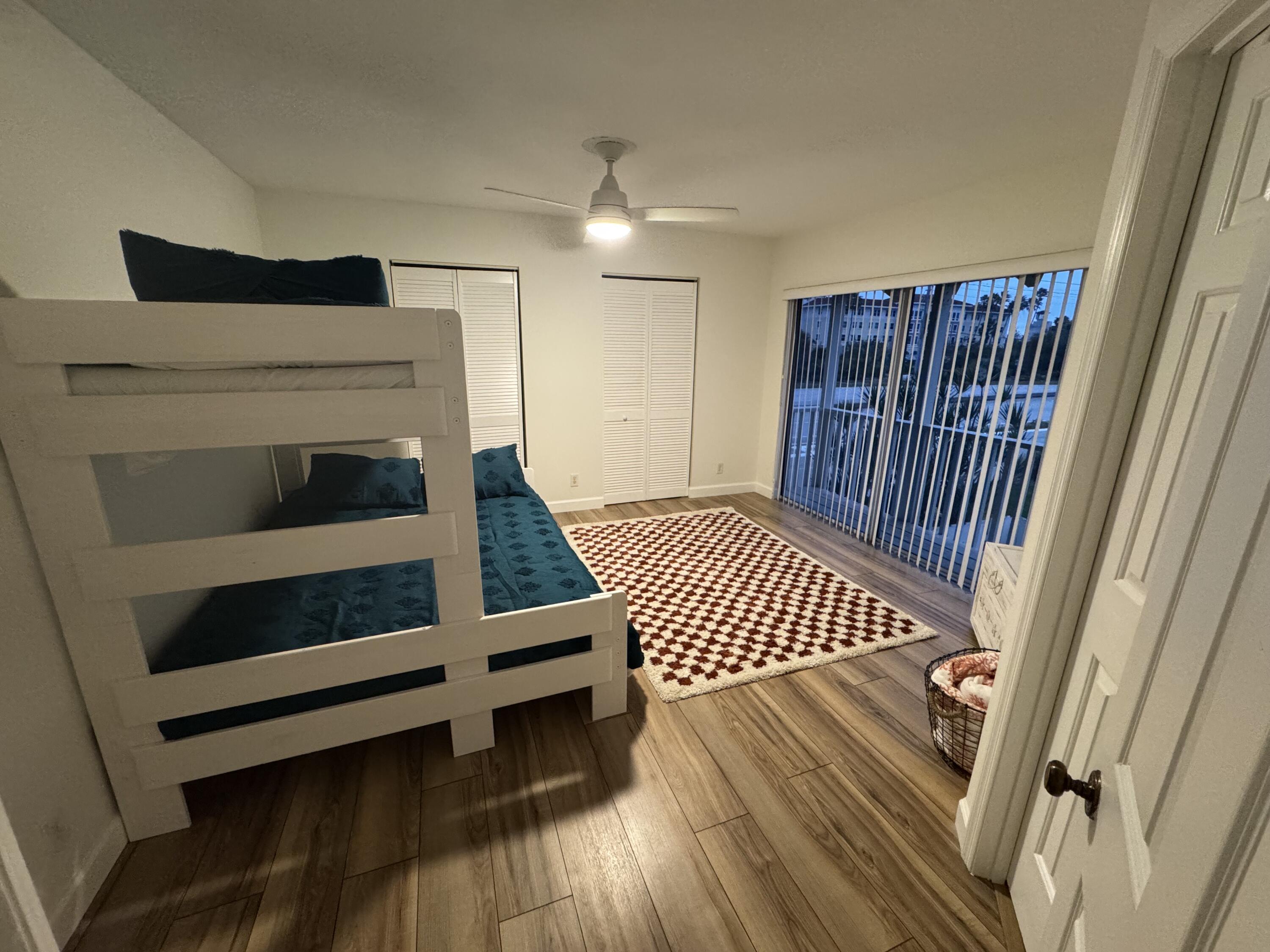 176 Seabreeze Circle Jupiter, FL 33477 - Photo 15 of 28 a bedroom with a bed and a dresser