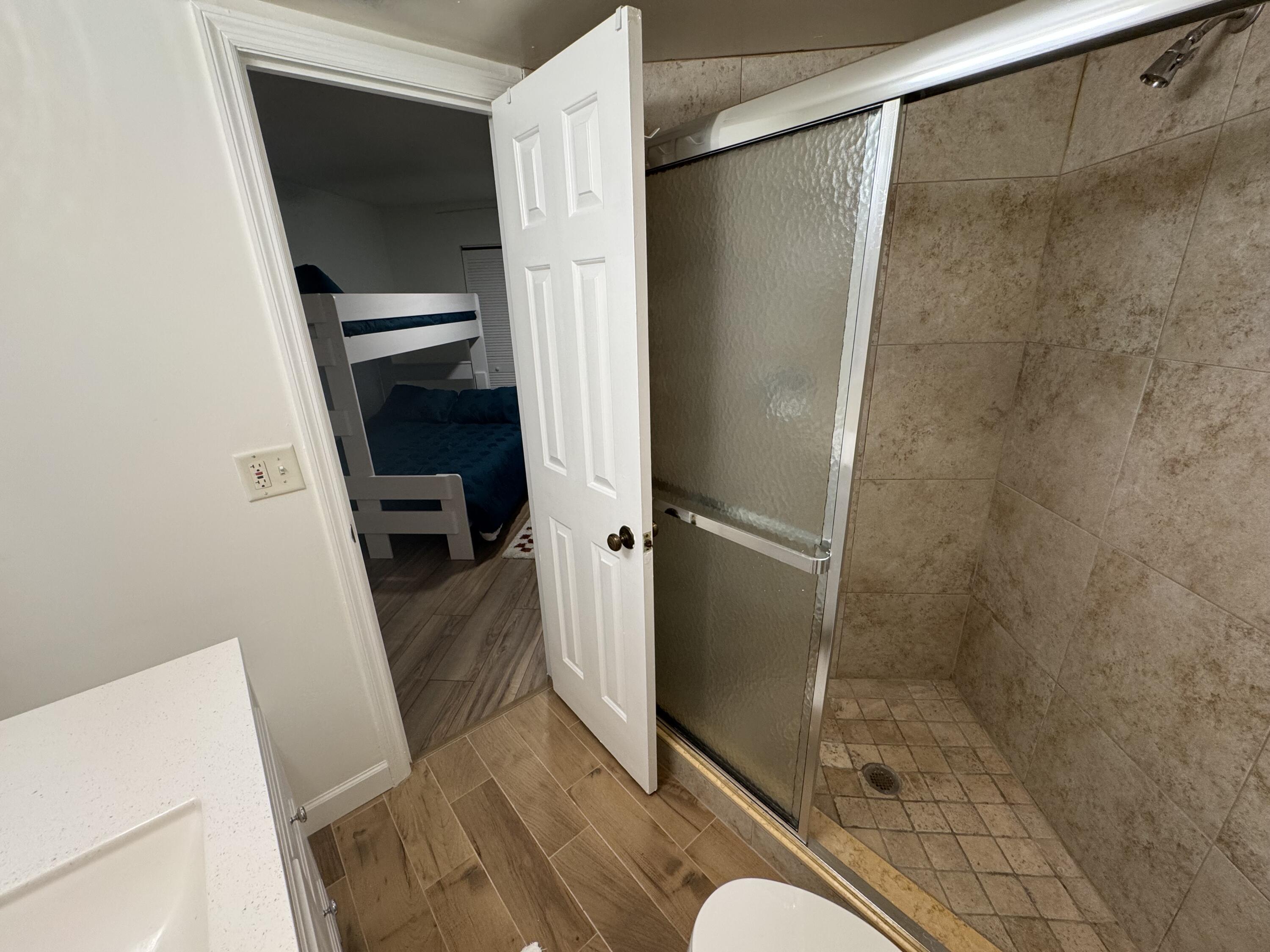 176 Seabreeze Circle Jupiter, FL 33477 - Photo 18 of 28 a bathroom with a shower and a sink