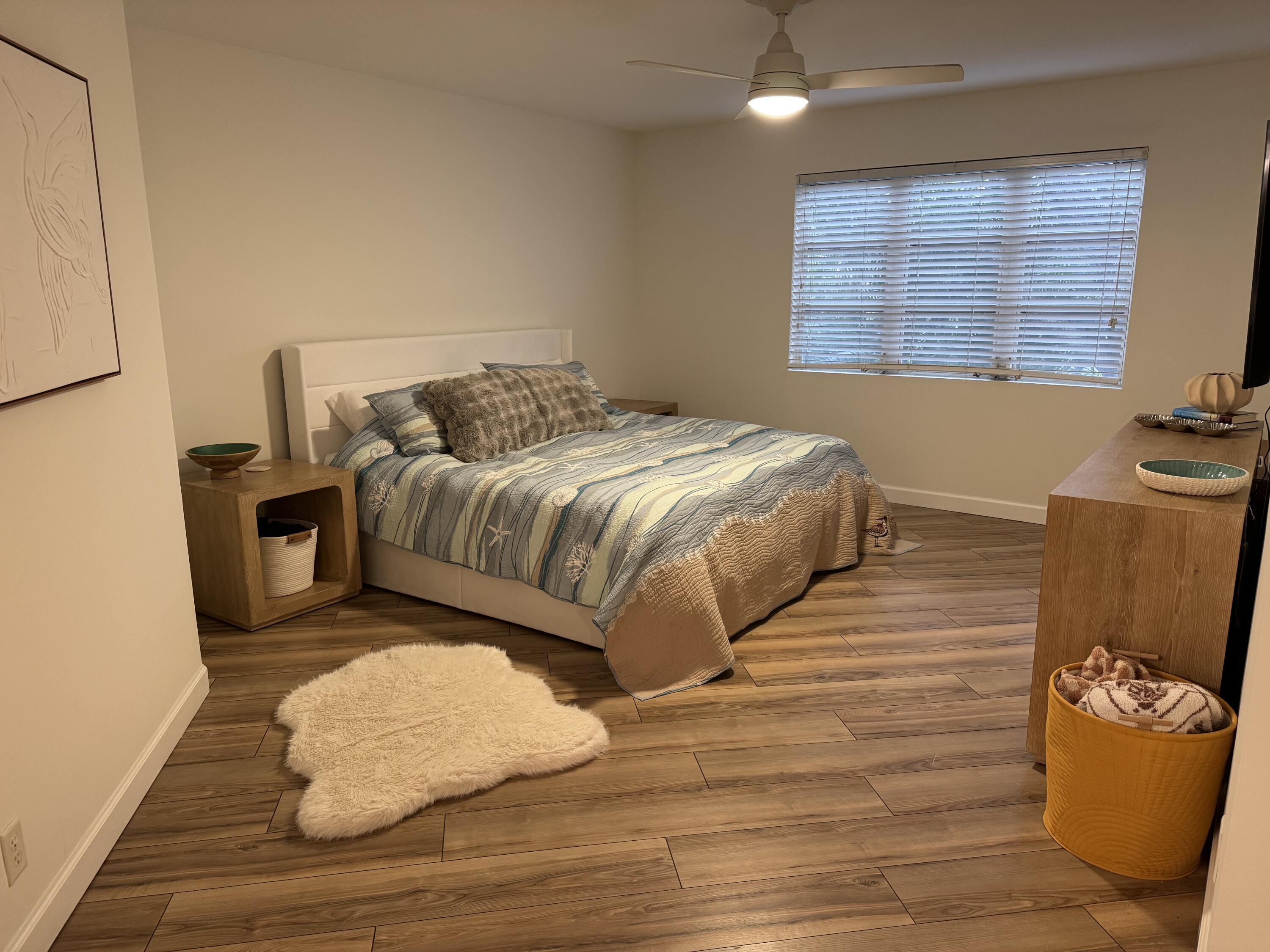 176 Seabreeze Circle Jupiter, FL 33477 - Photo 19 of 28 a bedroom with a bed and a large window