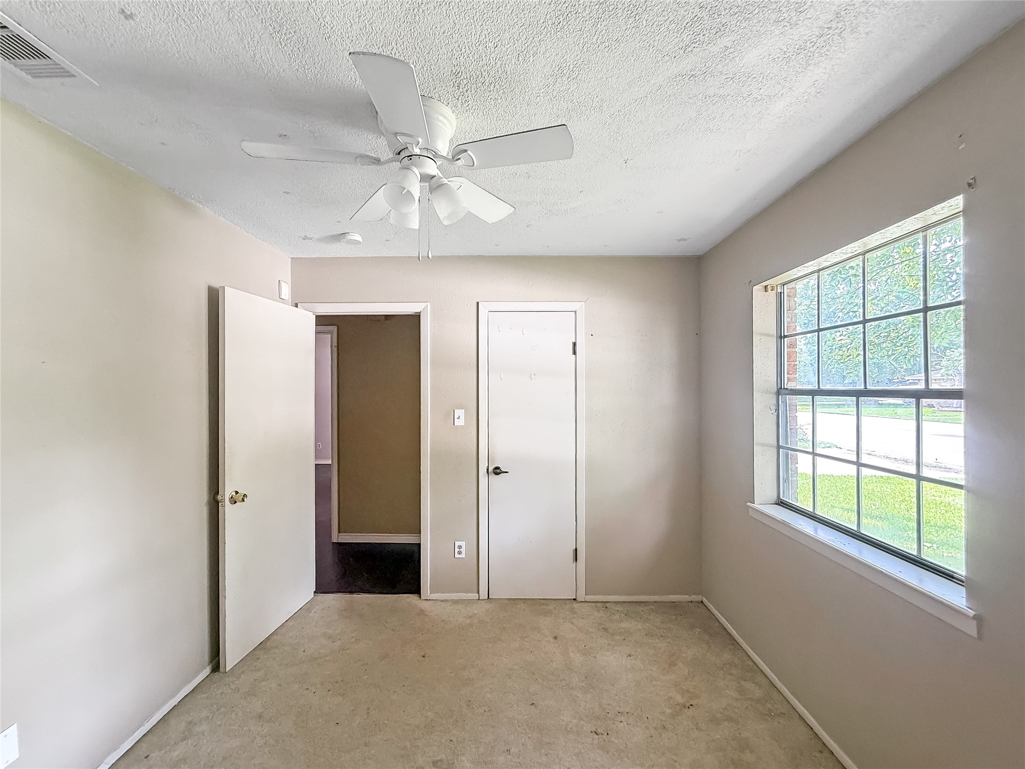 1413 Bay Ridge Boulevard Bay City, TX 77414 - Photo 15 of 20 an empty room with chandelier fan and windows