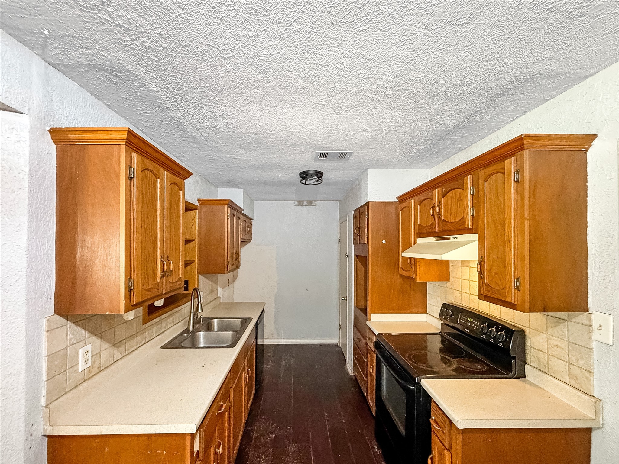 1413 Bay Ridge Boulevard Bay City, TX 77414 - Photo 5 of 20 a kitchen with stainless steel appliances granite countertop a stove a sink and a refrigerator