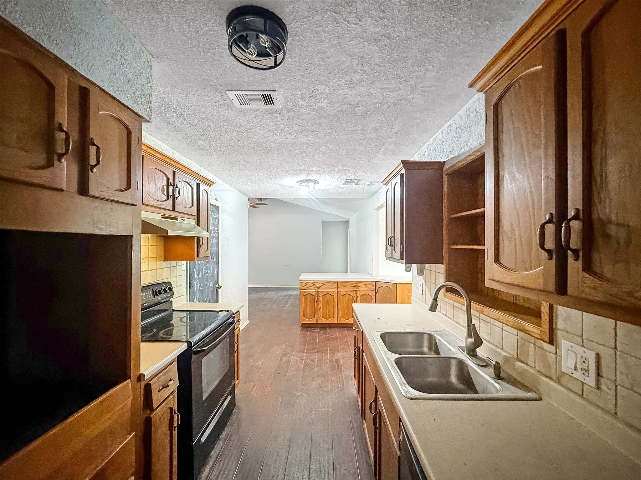 1413 Bay Ridge Boulevard Bay City, TX 77414 - Photo 6 of 20 a kitchen with stainless steel appliances granite countertop a sink and cabinets