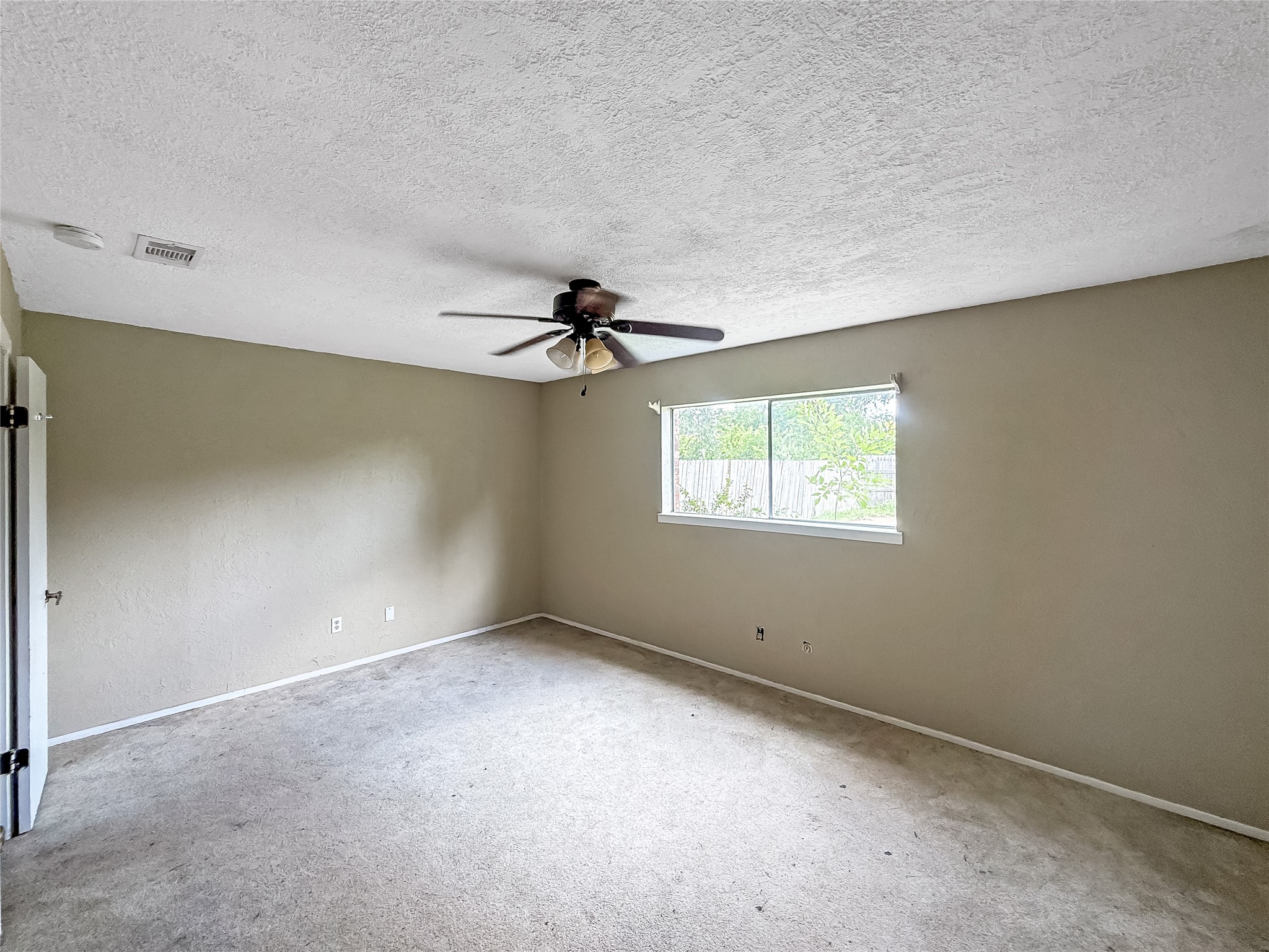 1413 Bay Ridge Boulevard Bay City, TX 77414 - Photo 9 of 20 an empty room with a window and a ceiling fan
