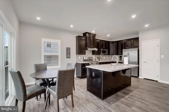a kitchen with kitchen island granite countertop a sink and stove