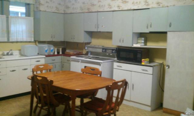 216 East Ruddle Street Coaldale, PA 18218 - Photo 8 of 8 a kitchen with a table chairs sink and cabinets