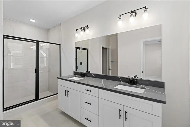 a bathroom with double sink and mirror
