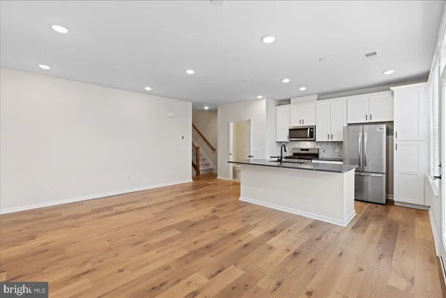a kitchen with stainless steel appliances a refrigerator and a stove top oven