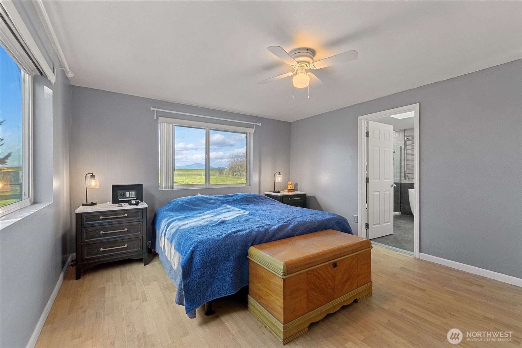 17771 Dunbar Road Mount Vernon, WA 98273 - Photo 19 of 38 a bedroom with a bed and a chandelier