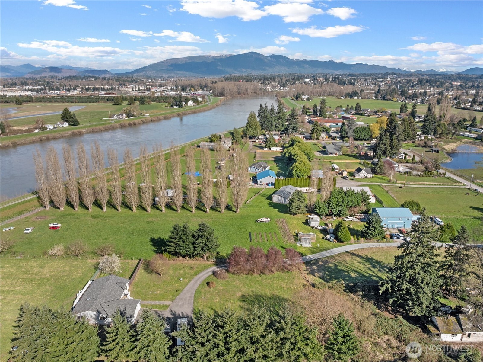17771 Dunbar Road Mount Vernon, WA 98273 - Photo 31 of 38 a view of a lake with a mountain in the background