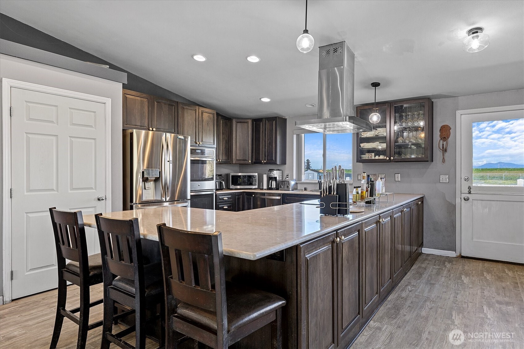 17771 Dunbar Road Mount Vernon, WA 98273 - Photo 6 of 38 a kitchen with stainless steel appliances granite countertop a kitchen island a stove a table and chairs