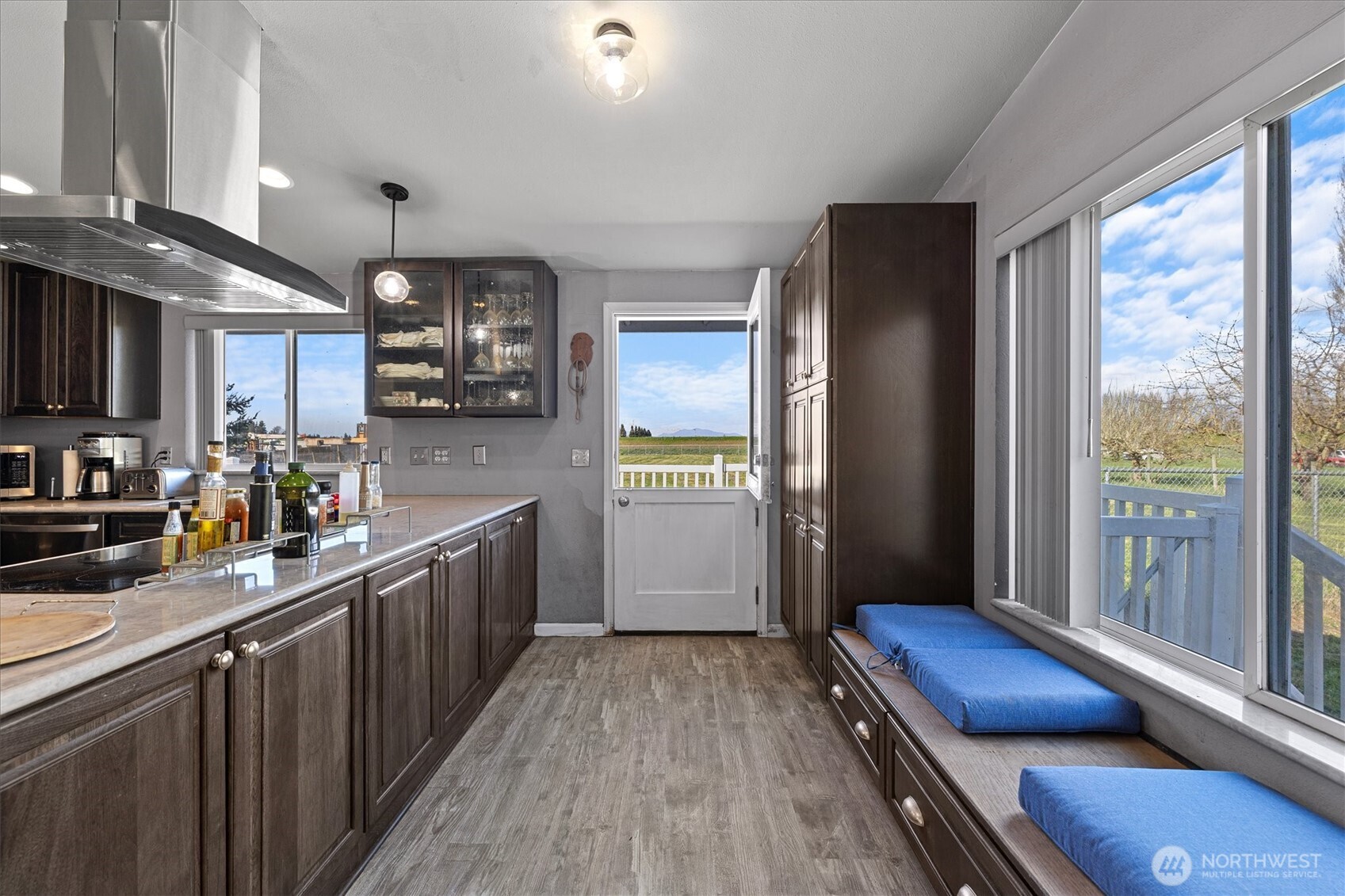 17771 Dunbar Road Mount Vernon, WA 98273 - Photo 8 of 38 a kitchen with stainless steel appliances granite countertop a refrigerator a sink dishwasher a stove and a dining table with wooden floor