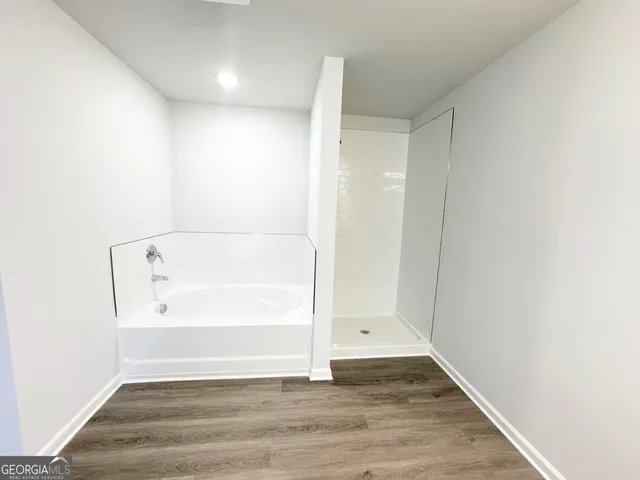 a view of bathroom with bathtub and window