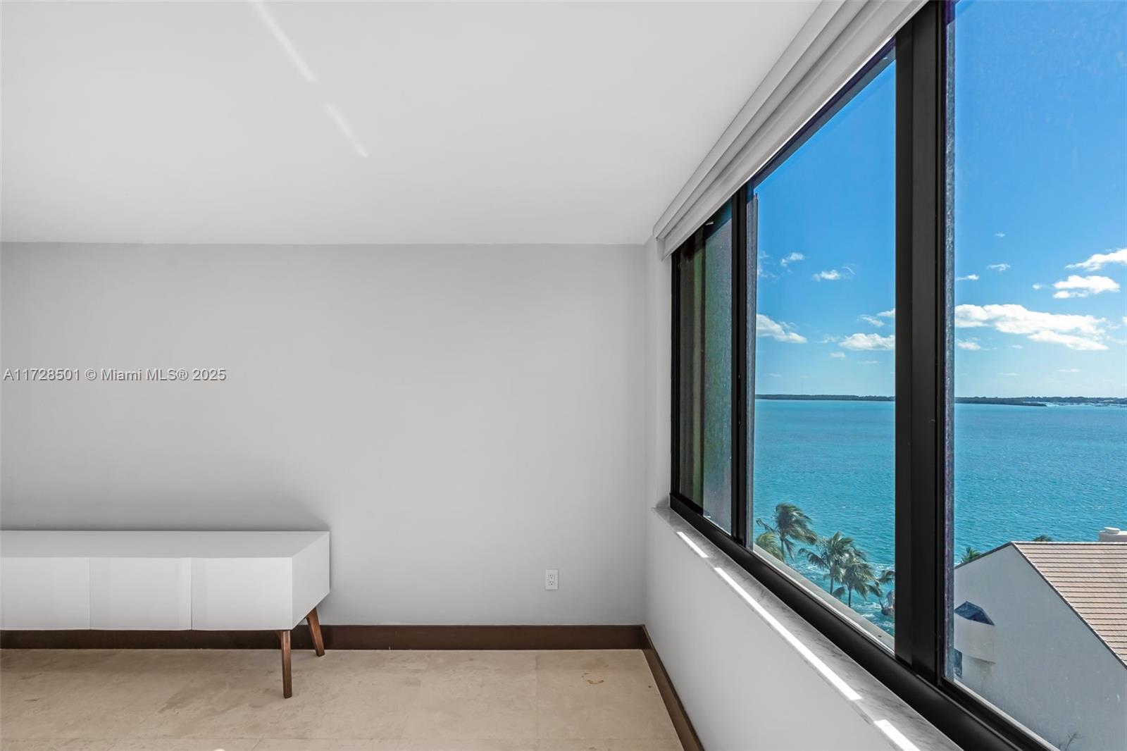 540 Brickell Key Drive, Unit 1021 Miami, FL 33131 - Photo 11 of 23 a view of a room with a large window and sitting area