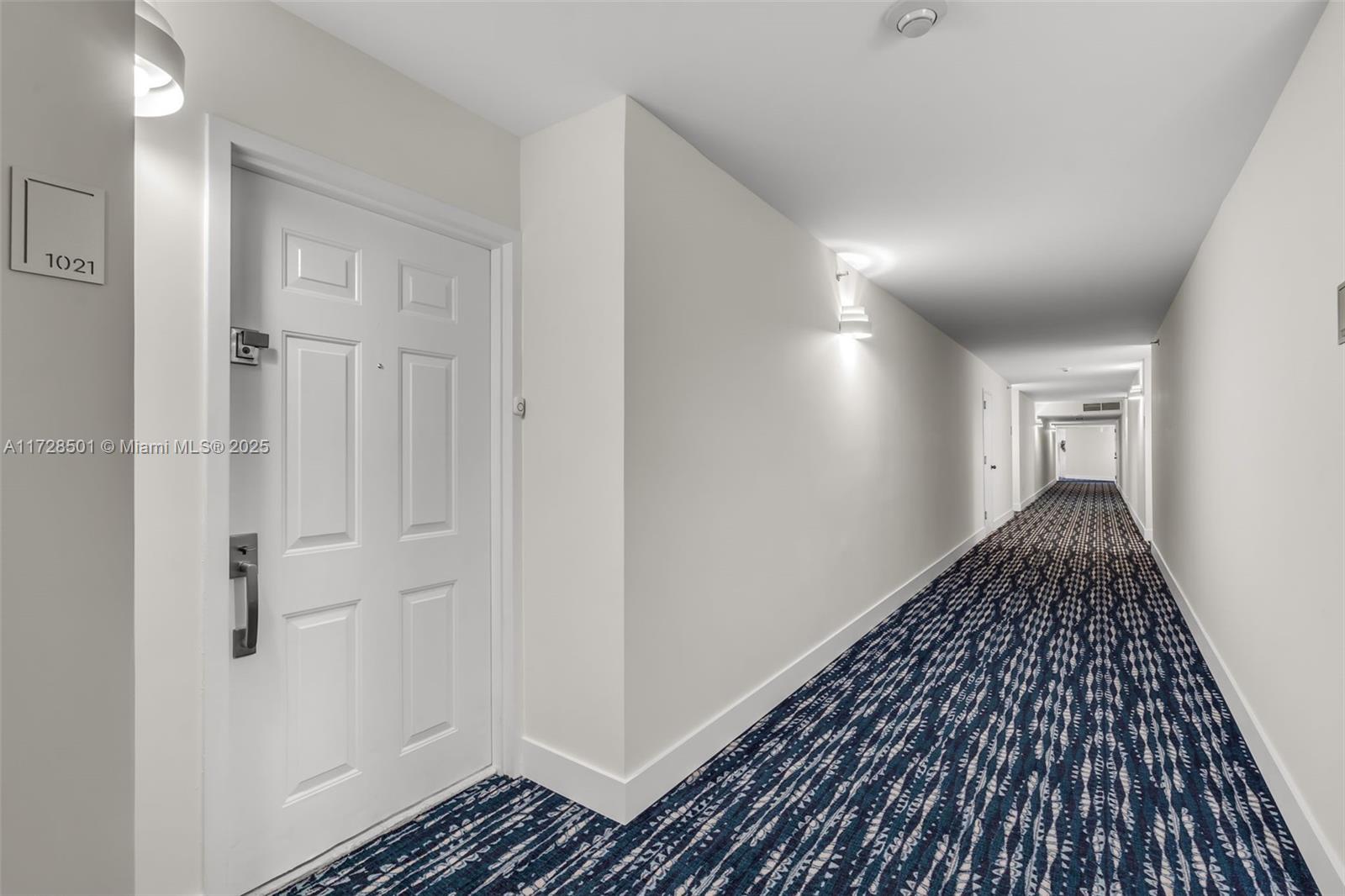 540 Brickell Key Drive, Unit 1021 Miami, FL 33131 - Photo 16 of 23 a view of a hallway view with wooden floor
