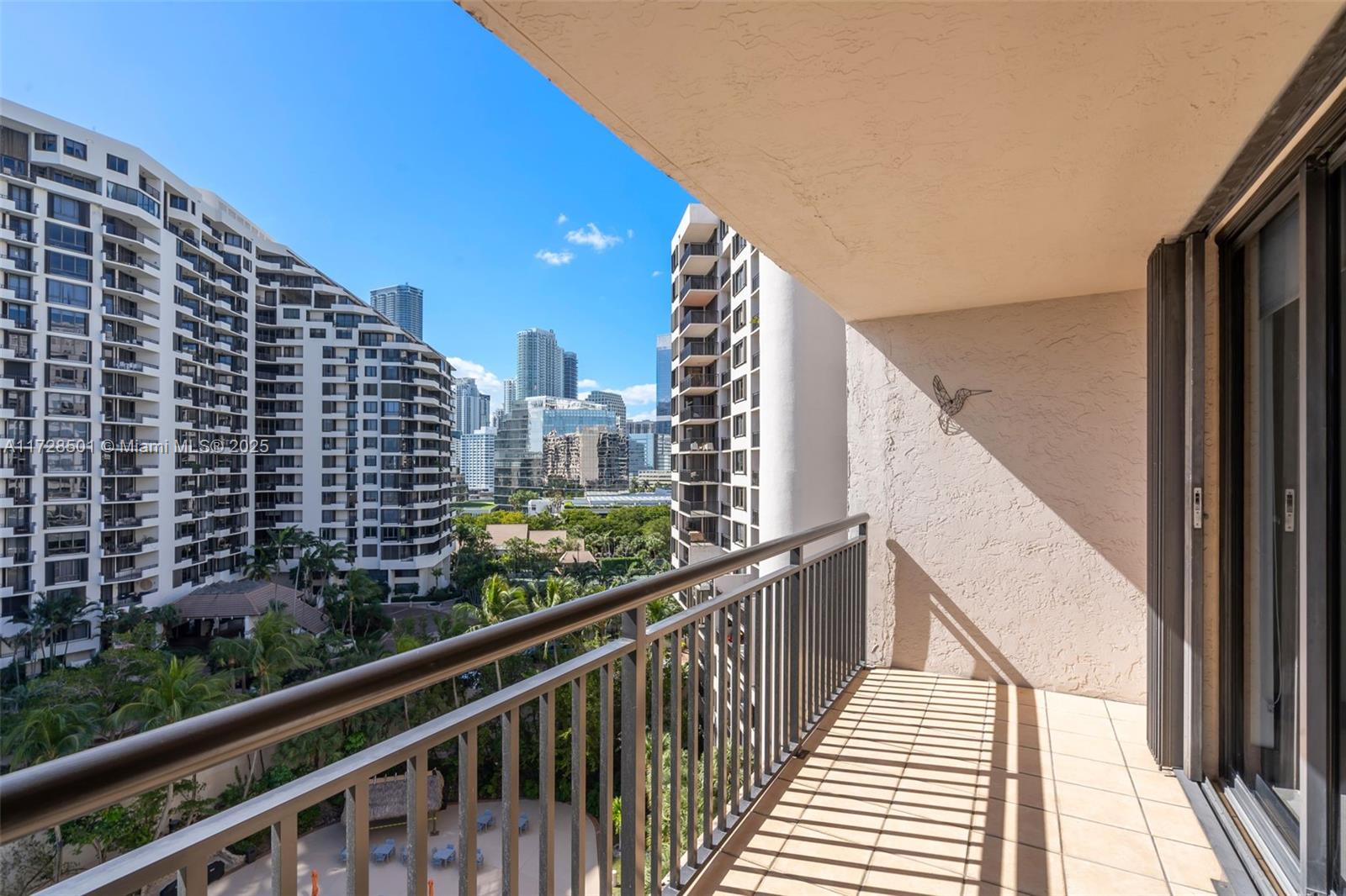 540 Brickell Key Drive, Unit 1021 Miami, FL 33131 - Photo 18 of 23 a view of a balcony with wooden floor and fence
