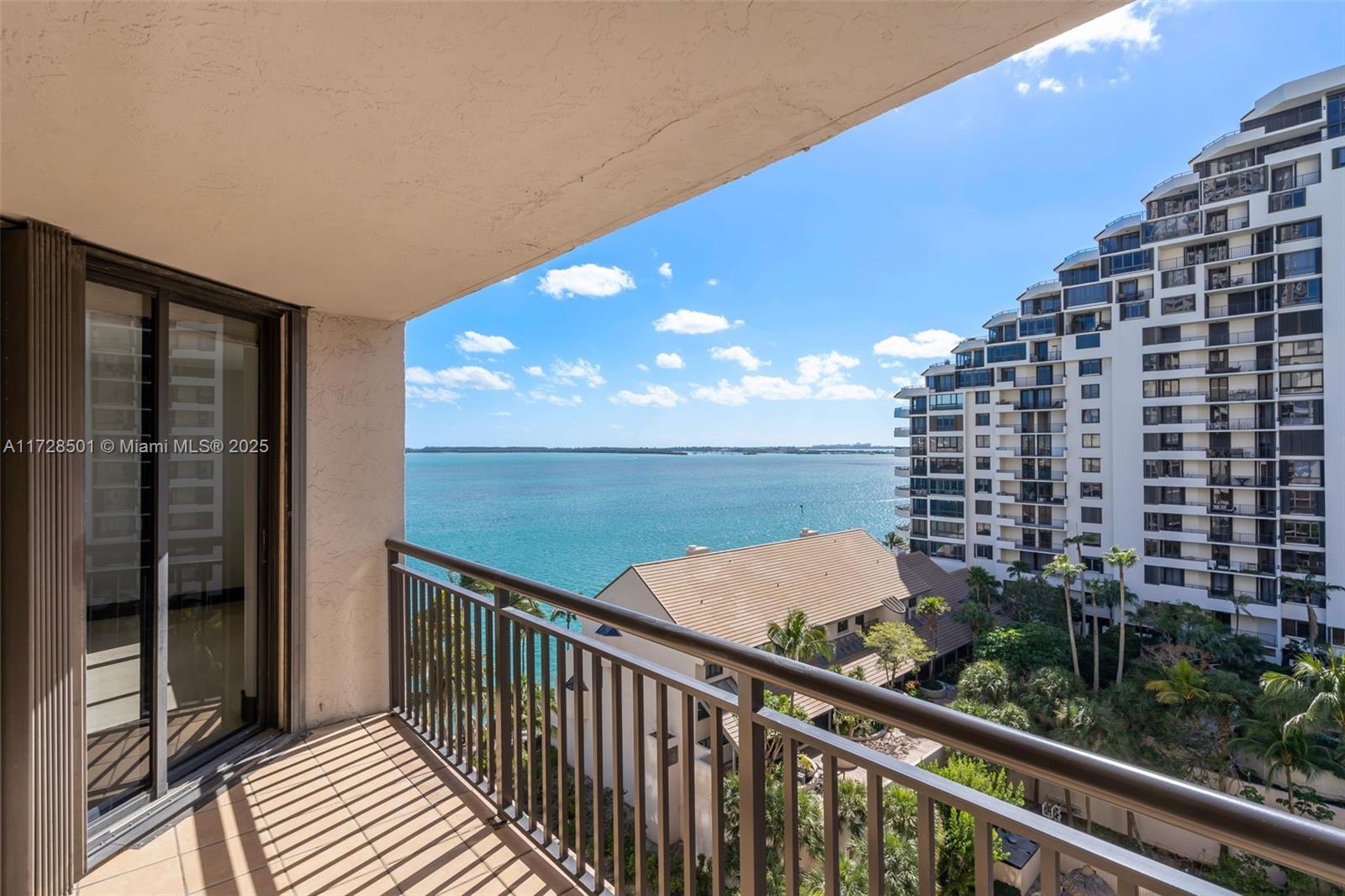540 Brickell Key Drive, Unit 1021 Miami, FL 33131 - Photo 19 of 23 a view of a balcony with wooden floor & fence