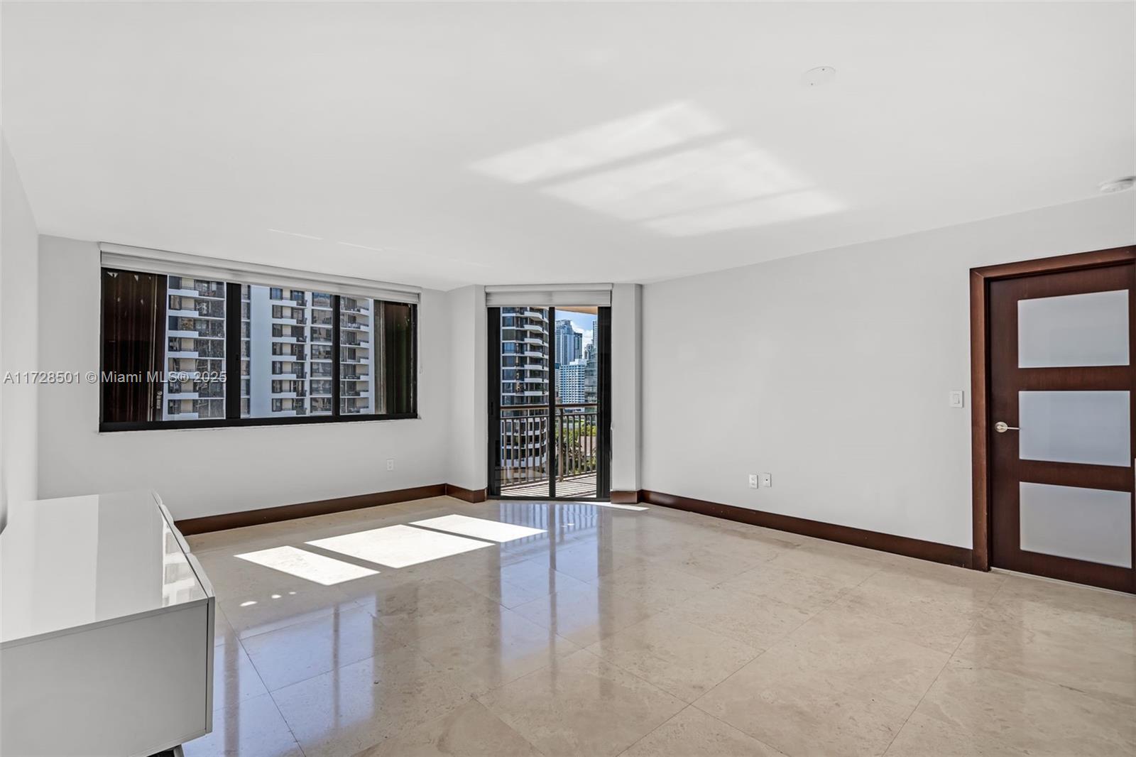 540 Brickell Key Drive, Unit 1021 Miami, FL 33131 - Photo 4 of 23 an empty room with windows