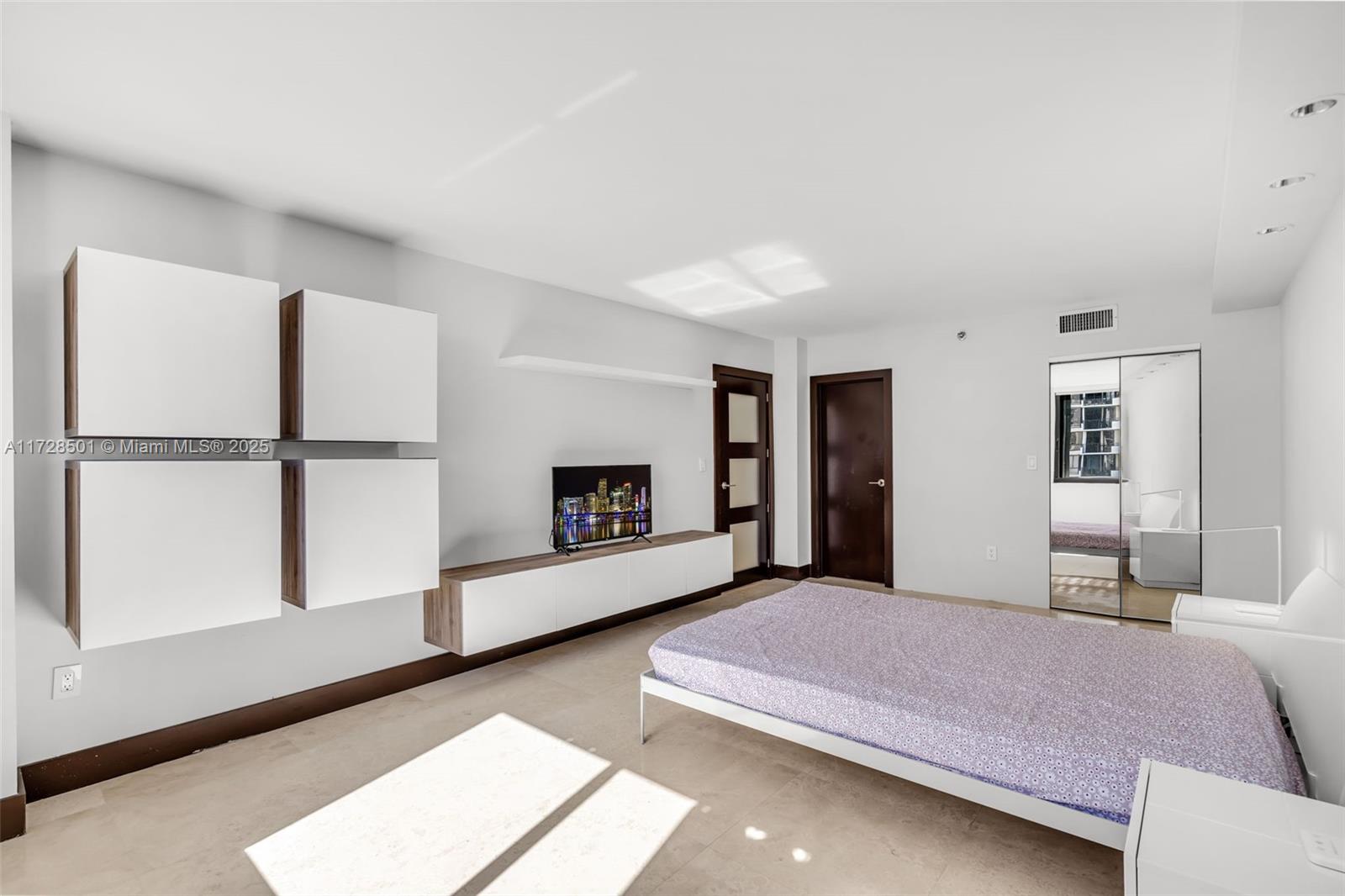 540 Brickell Key Drive, Unit 1021 Miami, FL 33131 - Photo 7 of 23 a bedroom with a bed and a large window