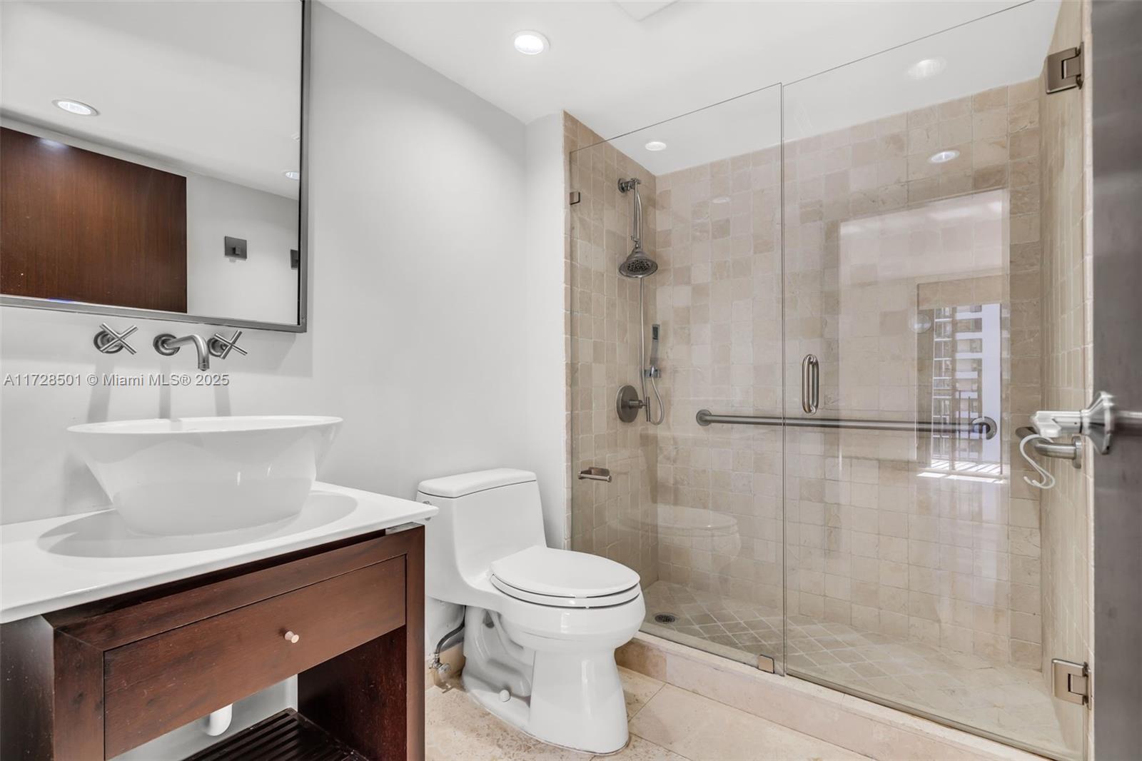 540 Brickell Key Drive, Unit 1021 Miami, FL 33131 - Photo 10 of 23 a bathroom with a toilet sink and shower