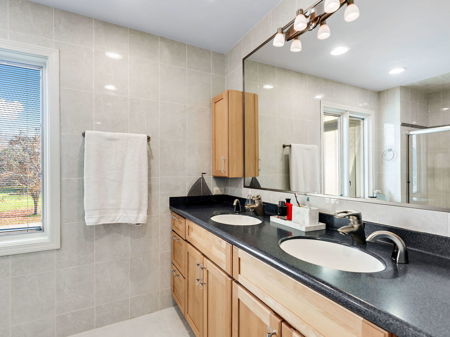 730 Valley Road Lake Forest, IL 60045 - Photo 19 of 33 a bathroom with a double vanity sink and a mirror