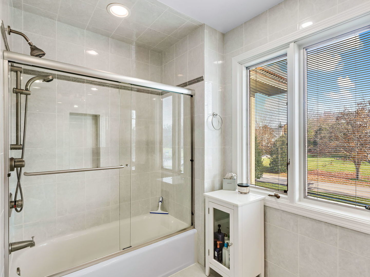 730 Valley Road Lake Forest, IL 60045 - Photo 20 of 33 a bathroom with a bathtub shower and windows