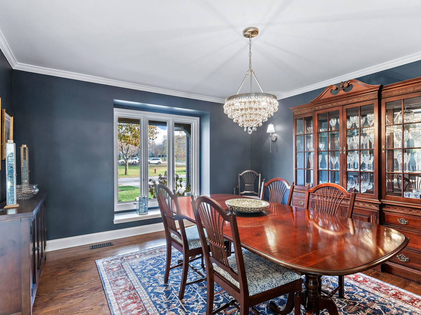730 Valley Road Lake Forest, IL 60045 - Photo 5 of 33 a dining room with furniture a chandelier and wooden floor