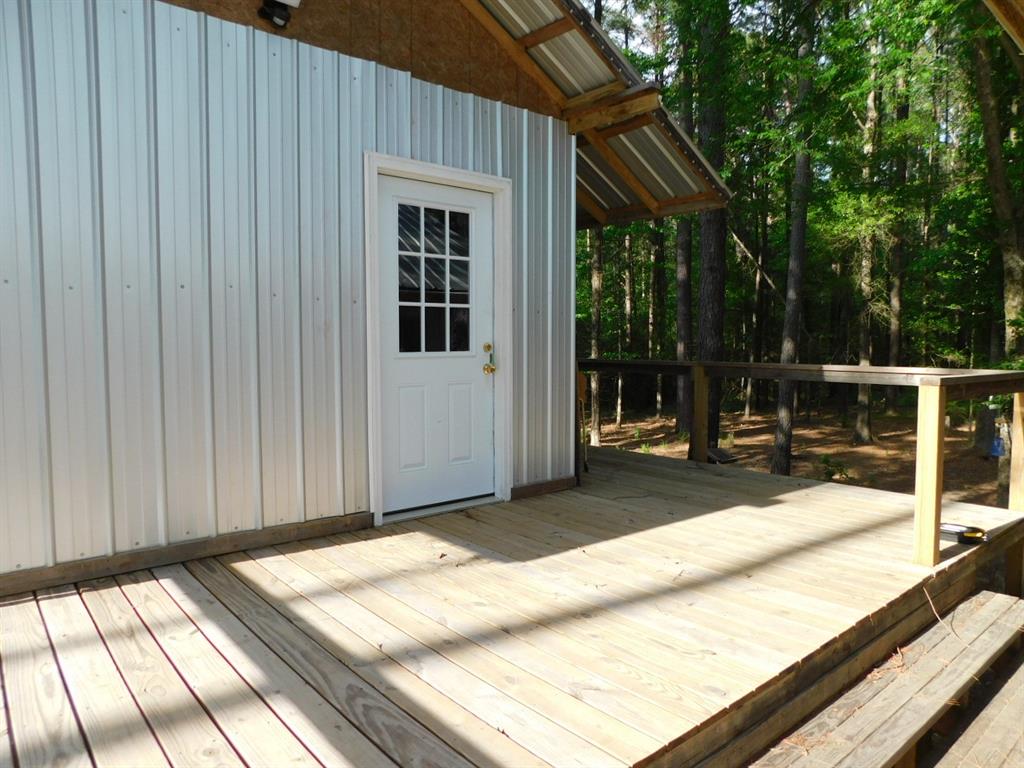 165 Rosewood Road Springhill, LA 71075 - Photo 14 of 27 a view of a house with backyard and porch