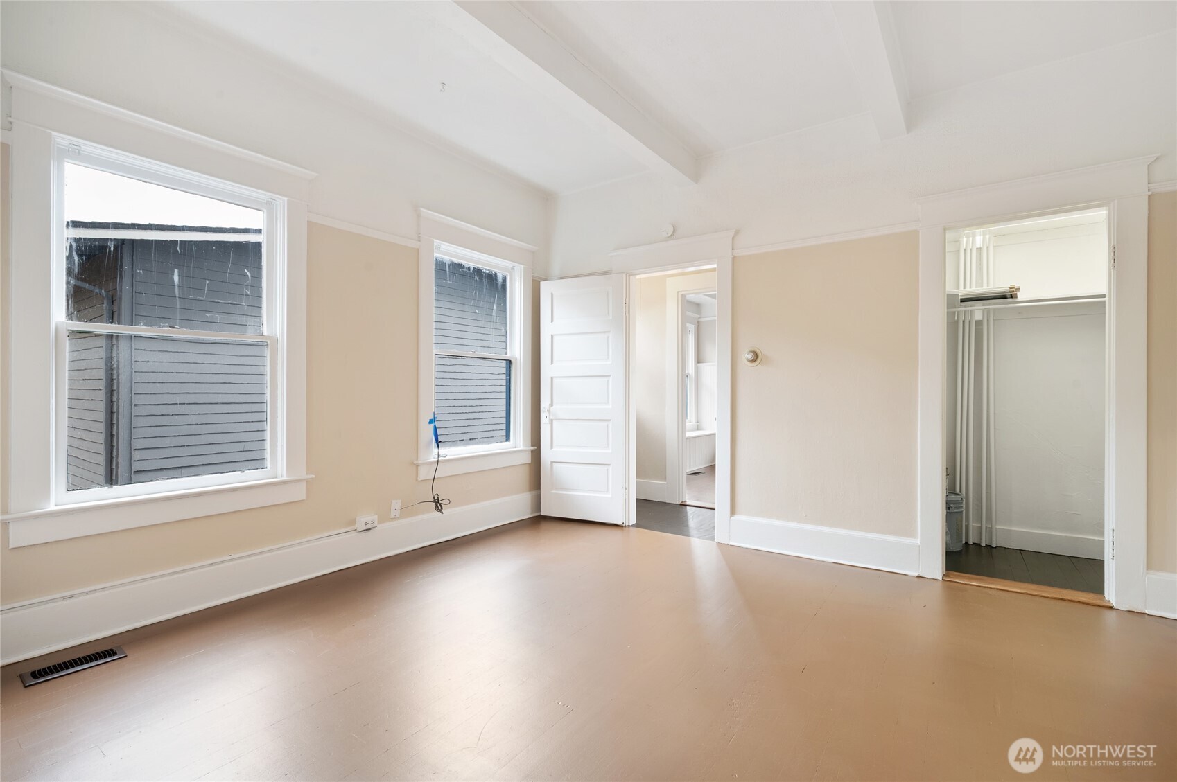 1425 Palm Avenue Southwest Seattle, WA 98116 - Photo 13 of 23 an empty room with wooden floor and windows