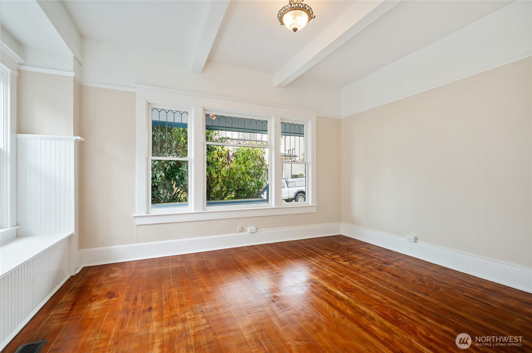 1425 Palm Avenue Southwest Seattle, WA 98116 - Photo 20 of 23 an empty room with wooden floor and windows