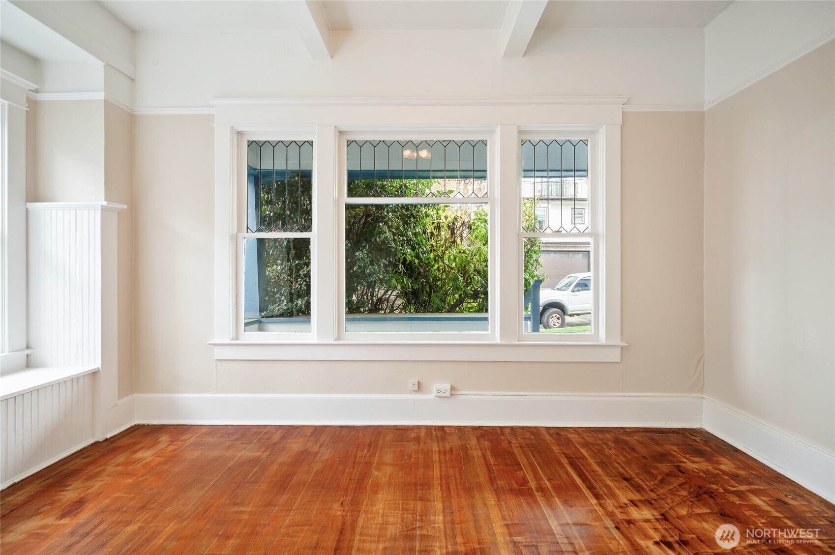 1425 Palm Avenue Southwest Seattle, WA 98116 - Photo 22 of 23 an empty room with wooden floor and windows