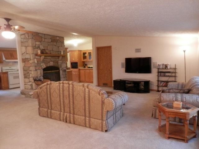 18402 Litzen Road Copemish, MI 49625 - Photo 2 of 34 Living Room/Stone FP & Surround Sound