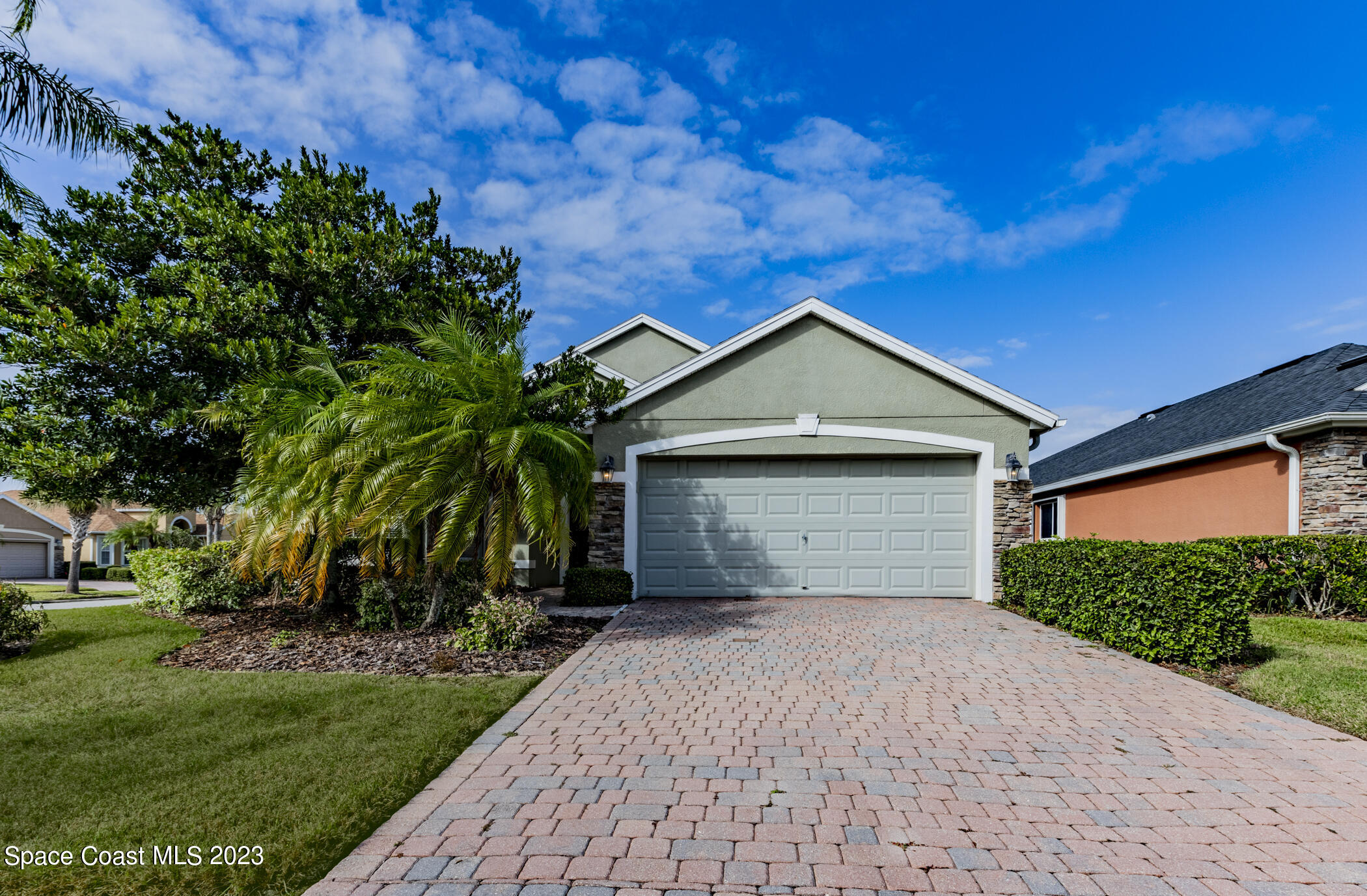 3102 Galindo Circle Melbourne, FL 32940 - Photo 1 of 31 a front view of a house with a yard and garage