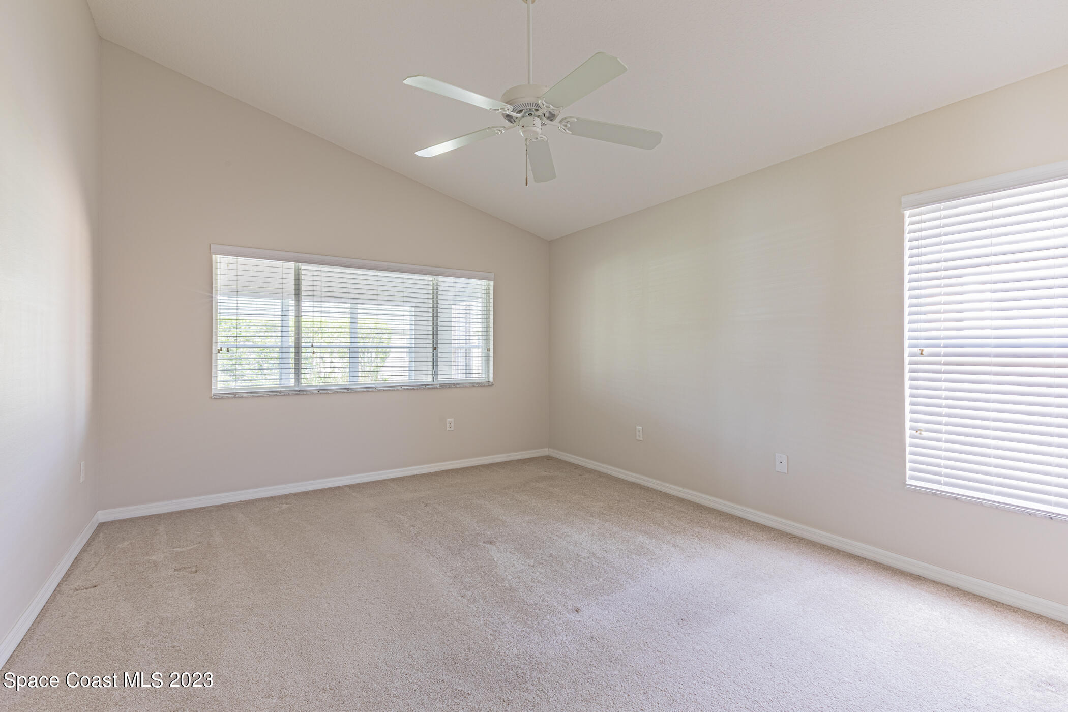 3102 Galindo Circle Melbourne, FL 32940 - Photo 18 of 31 an empty room with a window and a ceiling fan