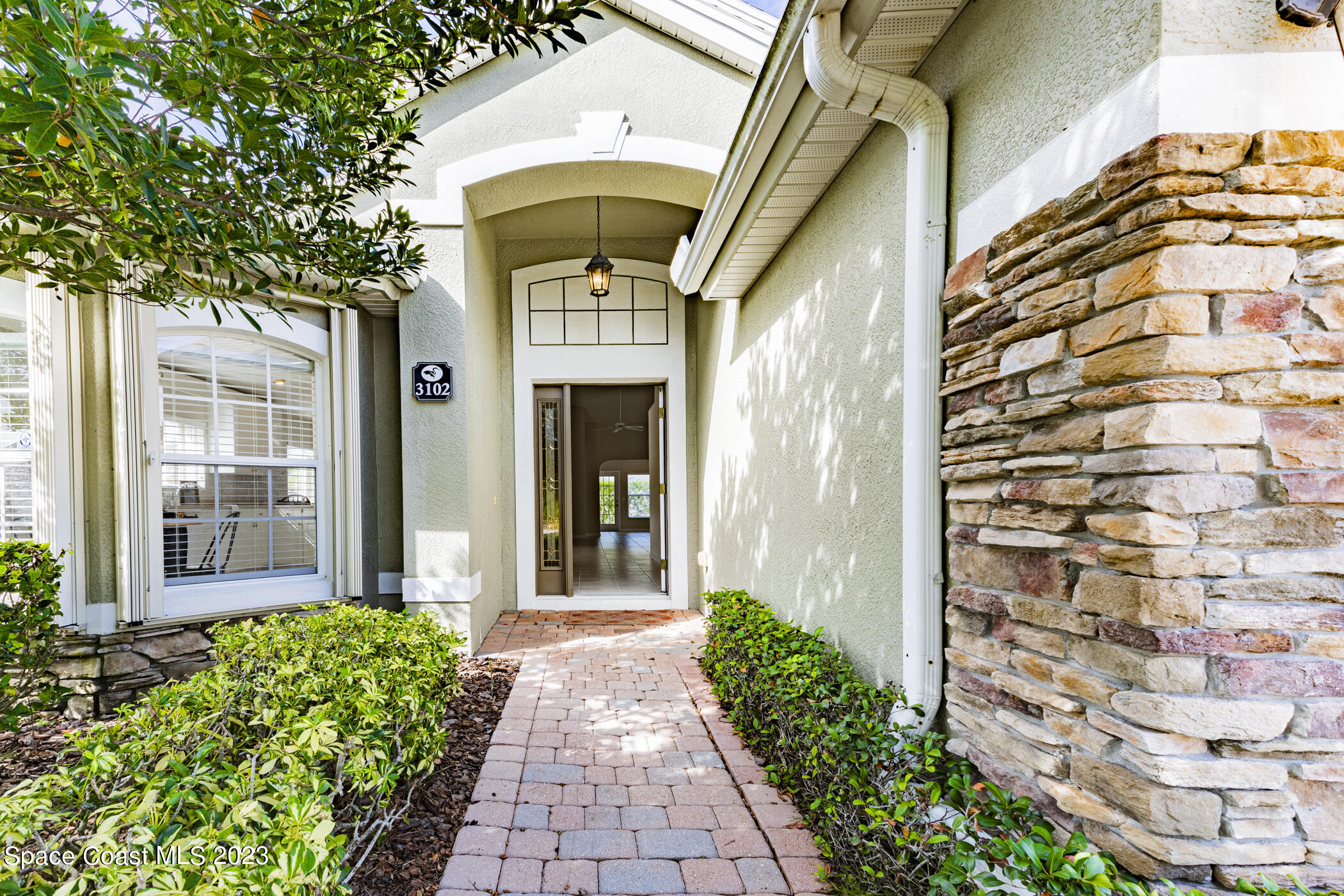 3102 Galindo Circle Melbourne, FL 32940 - Photo 2 of 31 a front view of a building with a garden