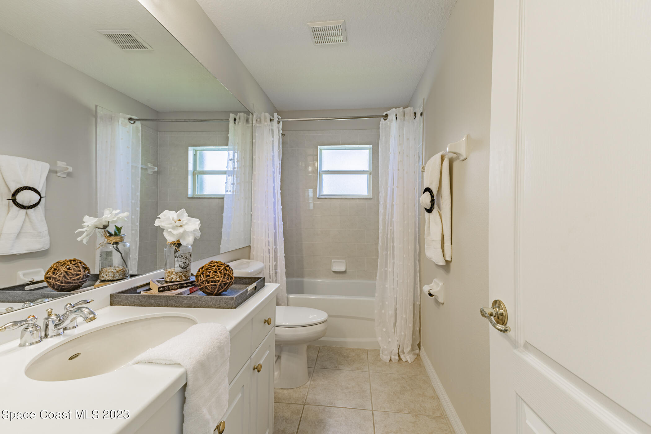 3102 Galindo Circle Melbourne, FL 32940 - Photo 29 of 31 a bathroom with a granite countertop sink and a mirror