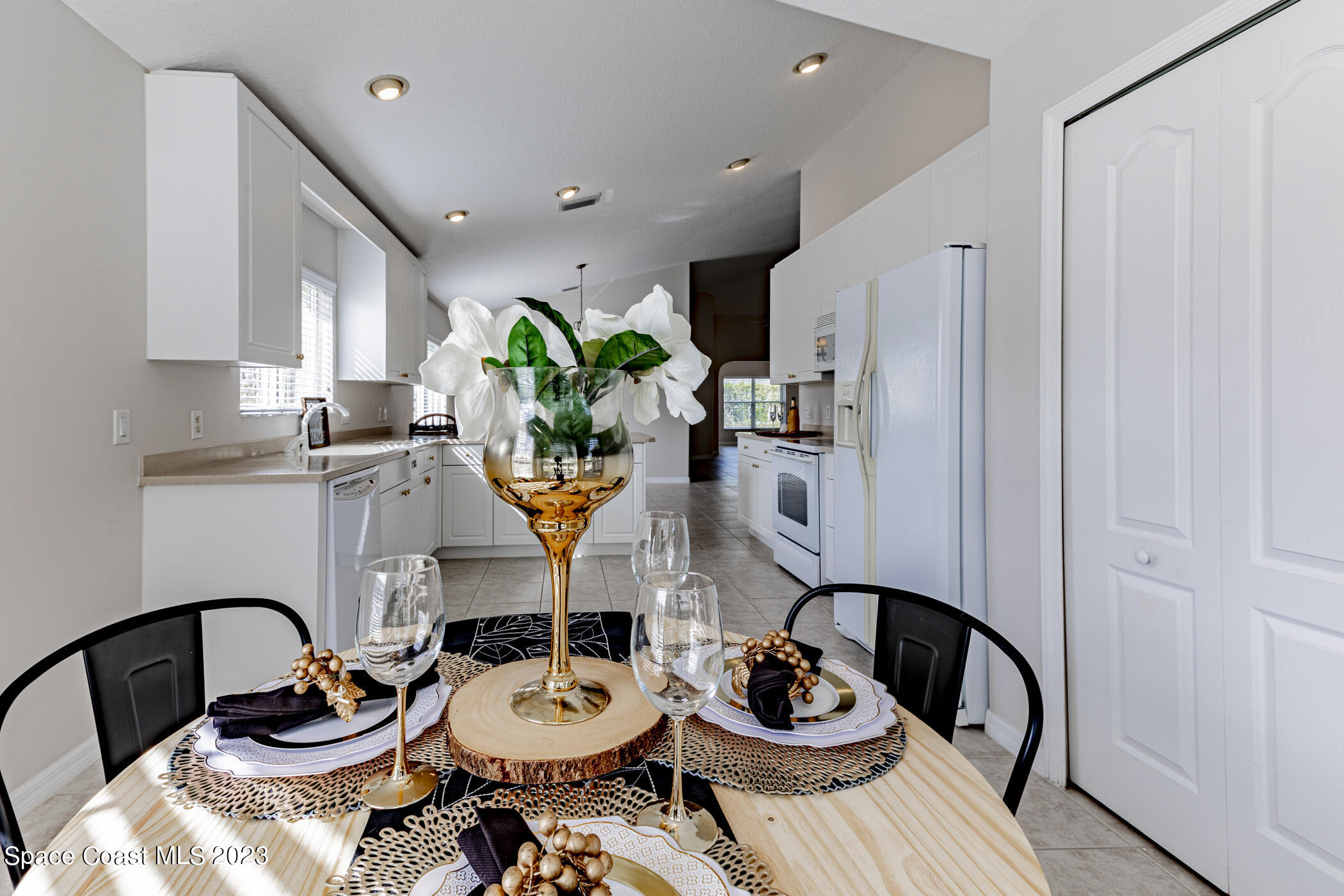 3102 Galindo Circle Melbourne, FL 32940 - Photo 7 of 31 a kitchen with stainless steel appliances a dining table and chairs