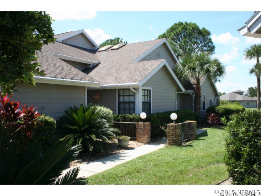 1993 Rutgers Place, Unit 43 Port Orange, FL 32128 - Photo 1 of 24 a front view of house with backyard and seating area