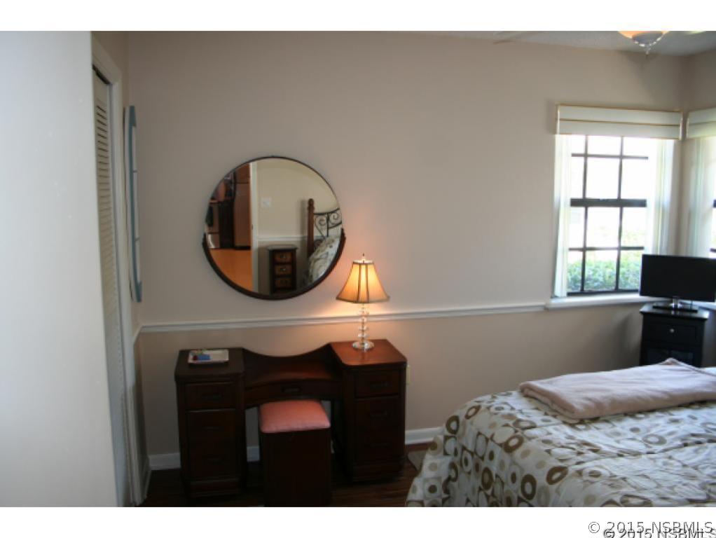 1993 Rutgers Place, Unit 43 Port Orange, FL 32128 - Photo 17 of 24 a bedroom with a bed and a window