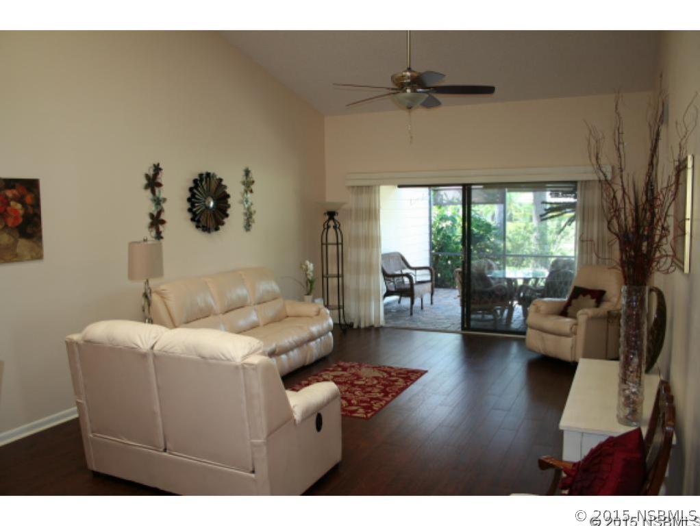 1993 Rutgers Place, Unit 43 Port Orange, FL 32128 - Photo 3 of 24 a living room with furniture and a large window