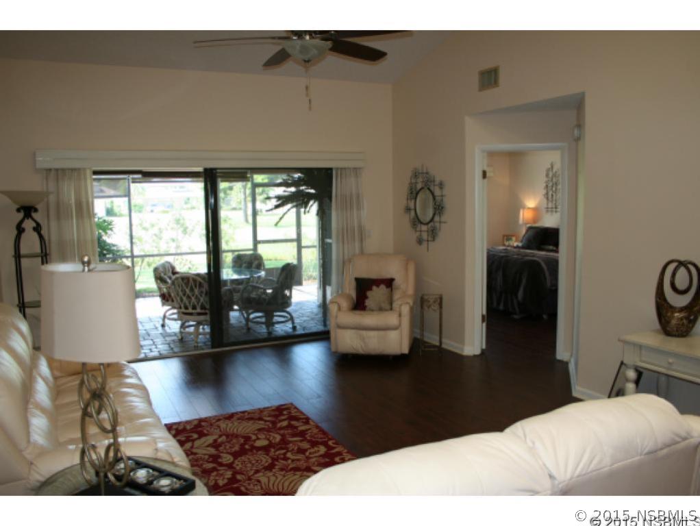 1993 Rutgers Place, Unit 43 Port Orange, FL 32128 - Photo 4 of 24 a living room with furniture and a large window