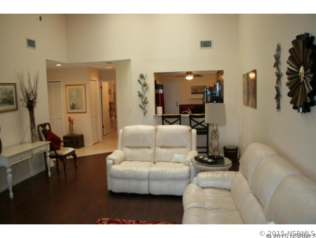 1993 Rutgers Place, Unit 43 Port Orange, FL 32128 - Photo 5 of 24 a living room with furniture and a flat screen tv