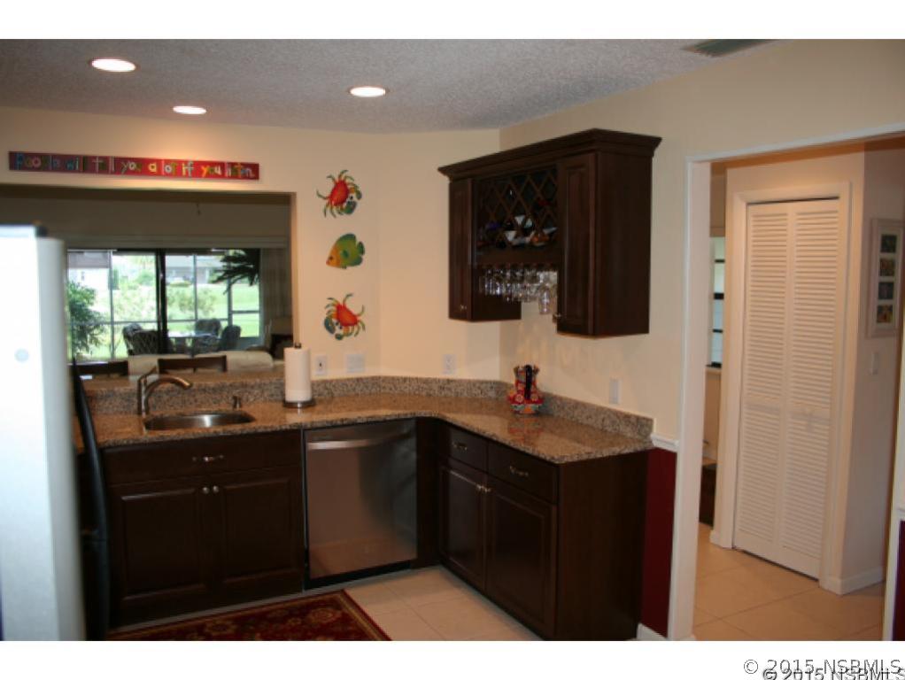 1993 Rutgers Place, Unit 43 Port Orange, FL 32128 - Photo 8 of 24 a kitchen with stainless steel appliances granite countertop a sink a stove and a refrigerator