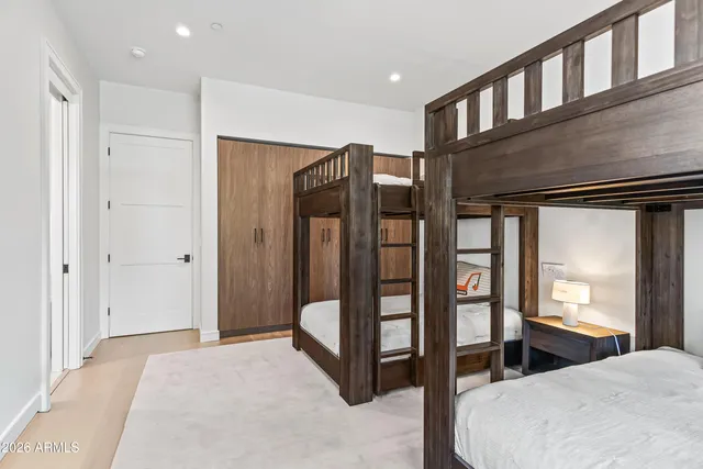 a bedroom with furniture and large window