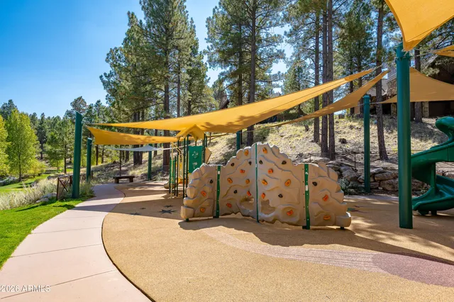 a view of a park with swings and slides