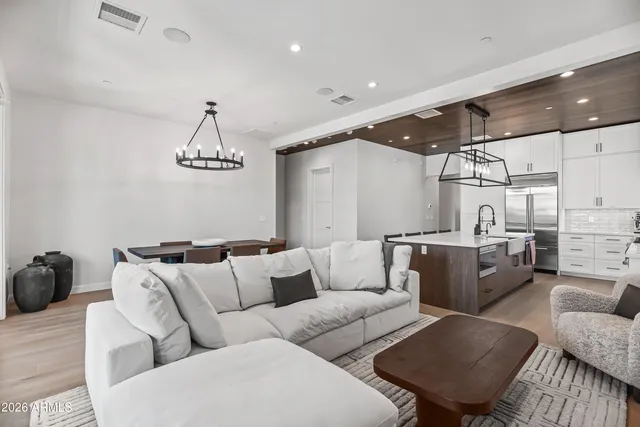 a living room with furniture a ceiling fan and a rug